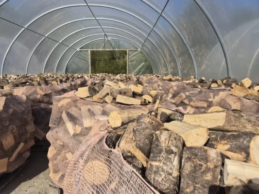 Bags of firewood filling a Kildare Logs polytunnel